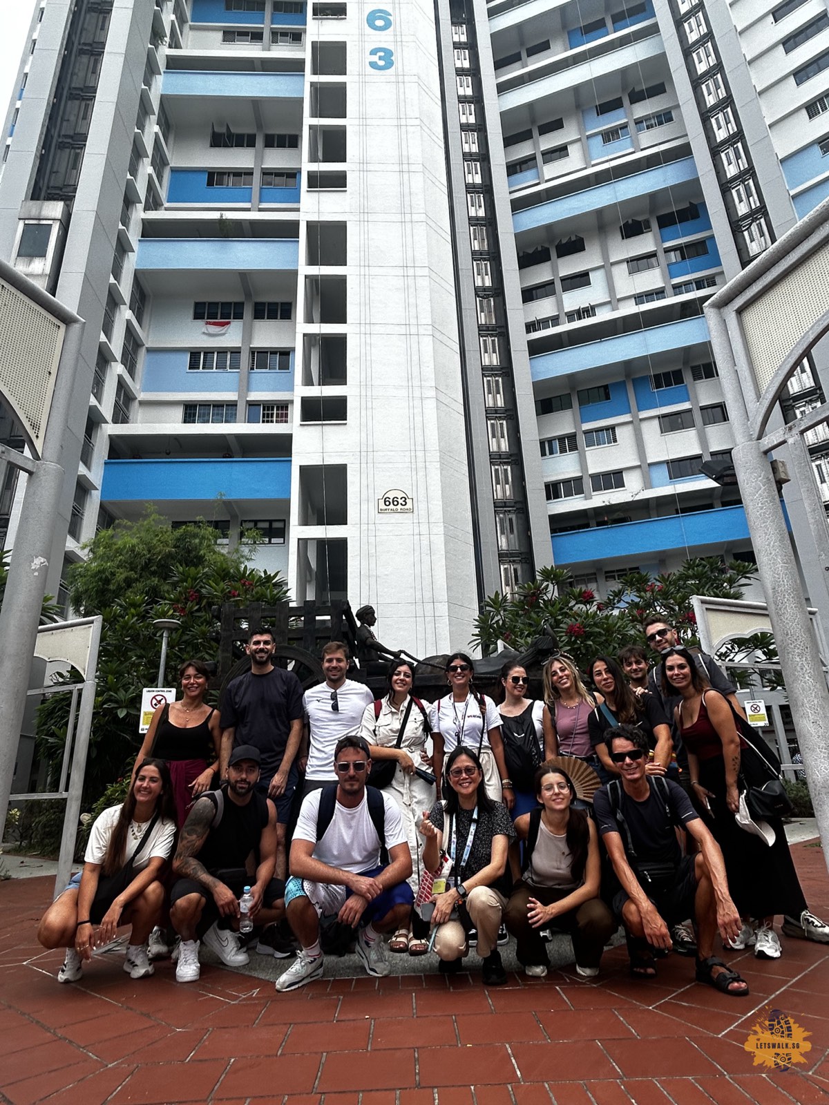 Female tourist guide with a walking tour group in Little India